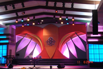 center stage styalized dove in painted hue of orange, red, yellow, black and white with magenta LED wash translucent panels with vibrant blue LED behind it , International Tabernacle, West Palm Beach, FL, USA