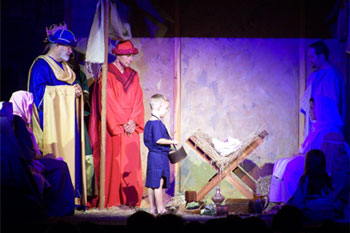 spot light with blue LED accent on stage, actors portraying wise men,holy family, small blond haired boy as the little drummer boy , Southpointe, Leesburg, FL, USA