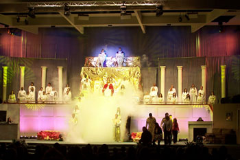 stage scene is the stairway to heaven with a person portraying Jesus with columns on both sides of stairs with angels and angels above Jesus in spotlight with people below waiting to be judged of Your Final Destination - Victory Church, Lakeland, FL, USA