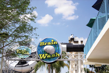 Brainwash Water Slide entrance with a 3-d brain with blues and greens swirling around it with Brain Wash in yellow and black letters mounted on a truss, Wet 'n Wild - Orlando, Florida, USA