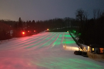 vibrant colors of red and green from LED fixutres illuminating the snow at Lunar Lights Tubing Peek 'n Peak Resort - Clymer, New York U.S.A.