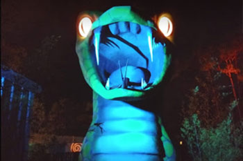 Colorful LED accent lighting at night of a large snake statue at Swampy Jack's Wongo Adventure, Panama City Beach, Florida, USA