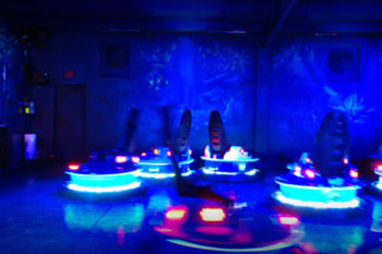 hues of blues with painted mural looks like you're under the sea with marine life Blue Hole Bumper Cars light up with a vibrant aqua blue with red accent lights at Swampy Jack's Wongo Adventure, Panama City Beach, Florida, USA