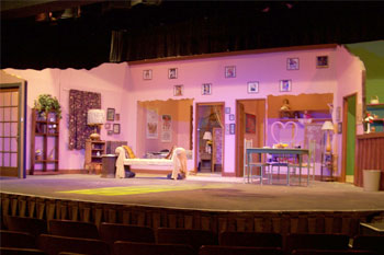 SGM Giotto 400 Spots and SGM Giotto 400 Wash fixtures with white light empty stage with Apartment set with assorted prop furniture, pink walls and lime green in a divided cutaway room with wood counter yellow lit window gobo, performers in different parts of the apartment on stage, Goodbye Girl, Osceola Center for the Arts, Kissimmee, Florida, USA