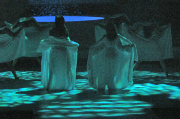 dancers with their backs towards the audience disrobing under a hue of aqua light and geometric gobo pattersn on the stage floor in the play Glamur, Sexo, Divas y Otras Mentiras - Teatro Nacional, Dominican Republic